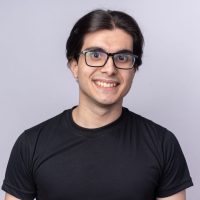 smiling young handsome guy wearing black t-shirt and glasses isolated on white background